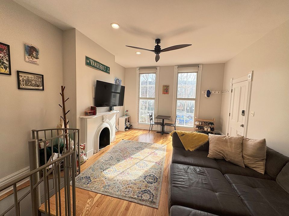 Closer living room view with the spiral stairs to the second level.