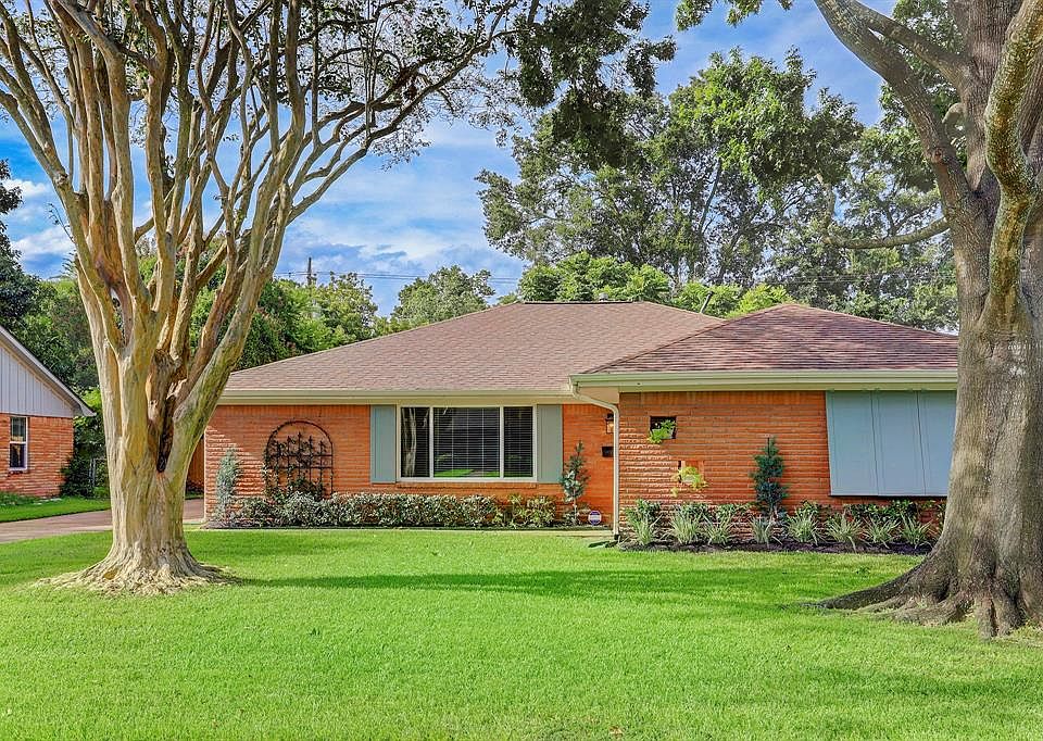 FRONT ELEVATION: Spectacular oak tree greet you as you drive up to all brick beauty with accented shutters and replaced windows.