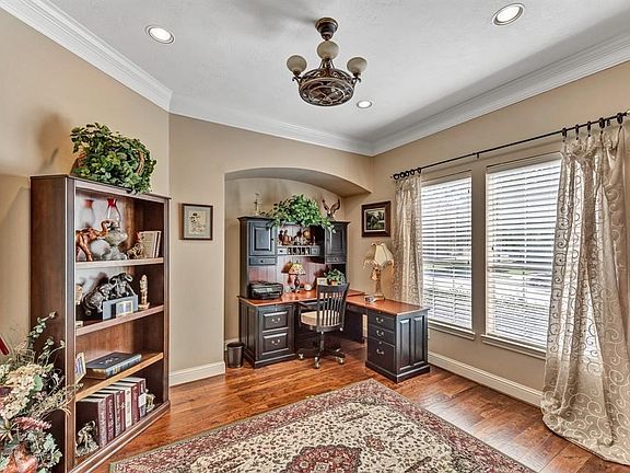 formal dining room with wood floors, picture frame and crown molding