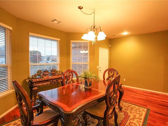 Dining room with bay window and just LOOK at the GORGEOUS tiger wood floor!