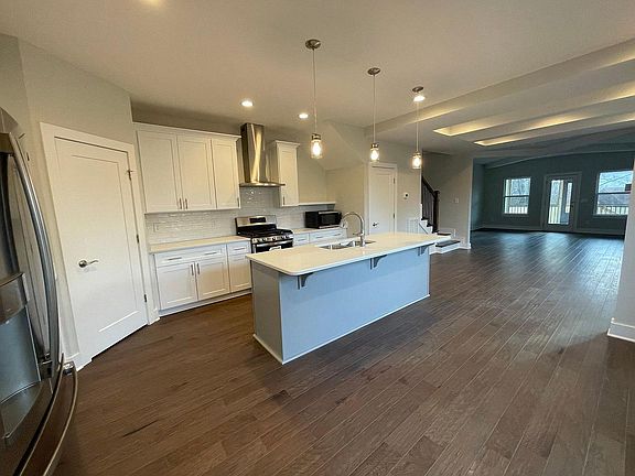 One bedroom with bathroom on main, opens to this HUGE open concept kitchen and living.