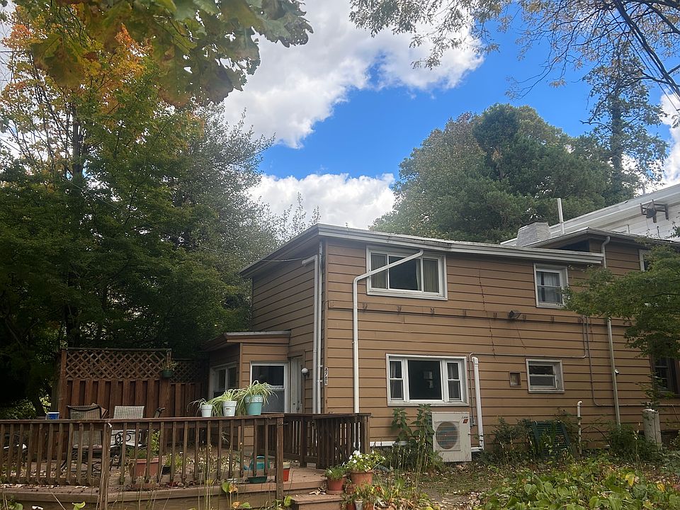 Side of house and deck with front door and yard
