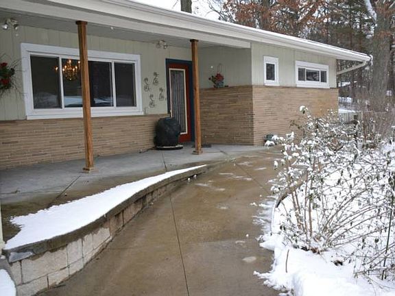 The walkway leading to the front entrance of the home is actually a cement handicap accessible ramp. It leads up to the covered front porch and right into the front entry of the home.