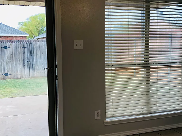 BONUS space!! This area is a sunroom situated off the kitchen. It is perfect for pets, a small work-from-home office, or coffee room.