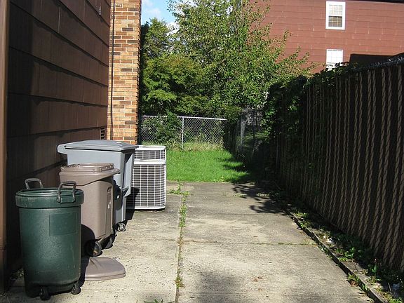 Right Side: Patio area or additional parking. Leads to fenced yard 