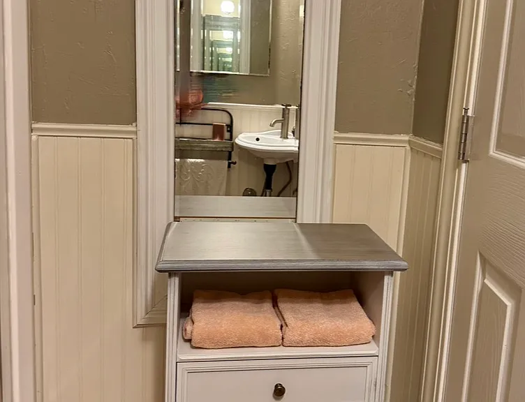 storage and mirror in small bathroom
