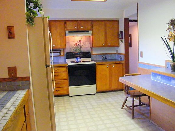 Kitchen w/original birch cabeints, tile backspash, built in eating