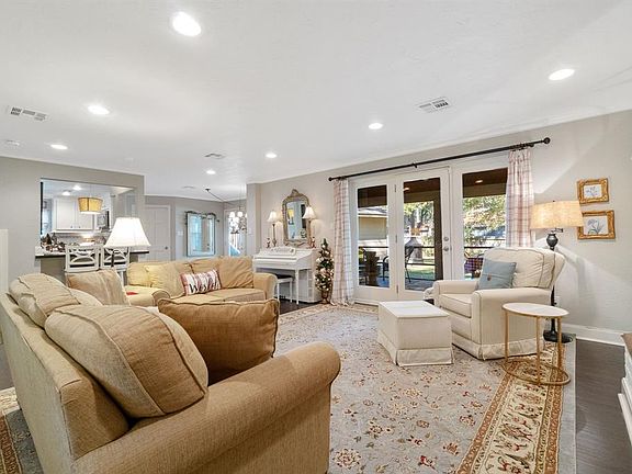 Cozy family room overlooking screened porch and huge backyard. There's a fireplace, built-ins and effortless flow into the breakfast room and kitchen.