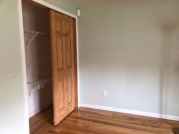 Bedroom fits up to a queen sized bed with a dresser . Hardwood floors, double closet, large window