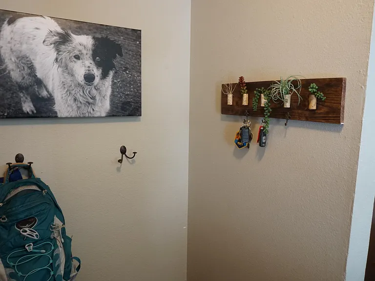 behind the front door, hooks and bench.
