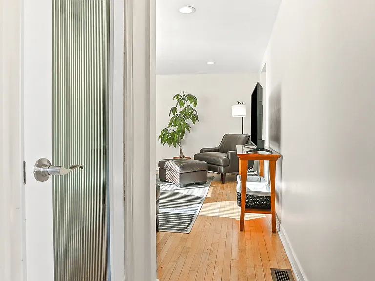 Front entry into living room. The coat closet to the left.