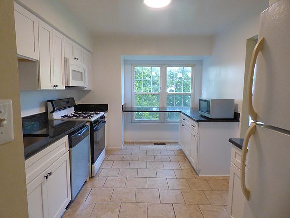 Bright kitchen with granite countertops and new wooden cabinets.