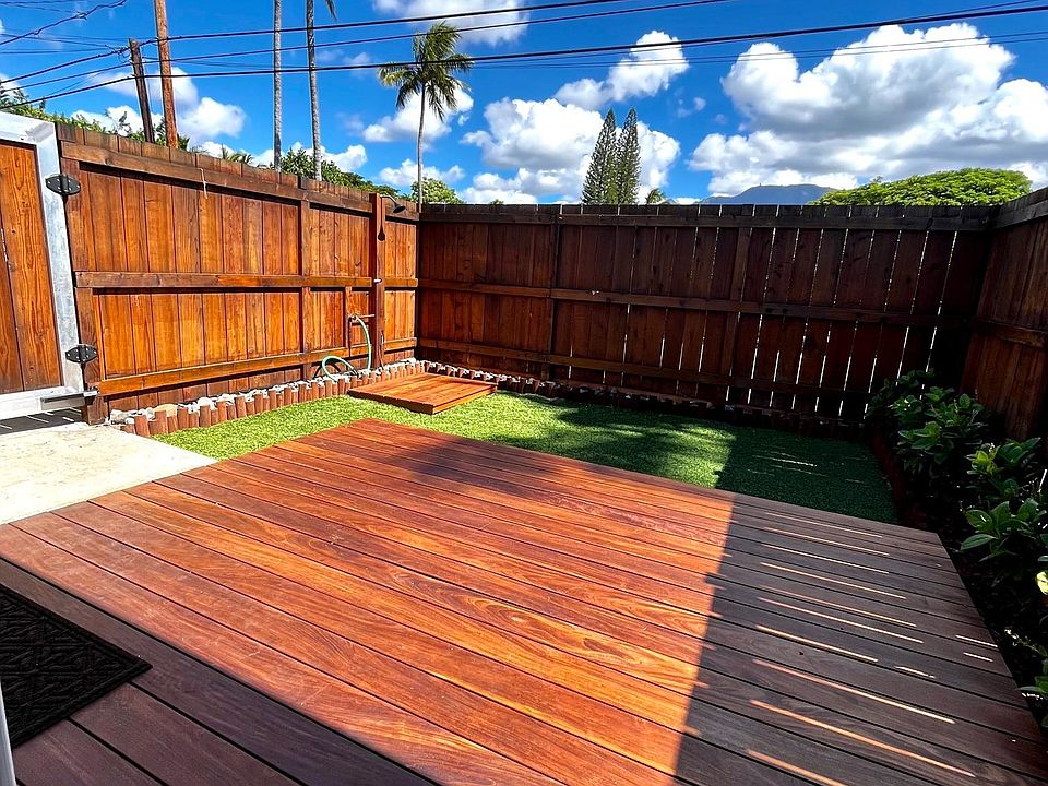 Ipe deck with artificial grass for minimal maintenance. Outside shower and hose