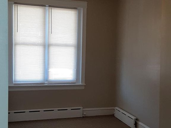 Spacious master bedroom with ceiling fan and brand new wall to wall carpeting