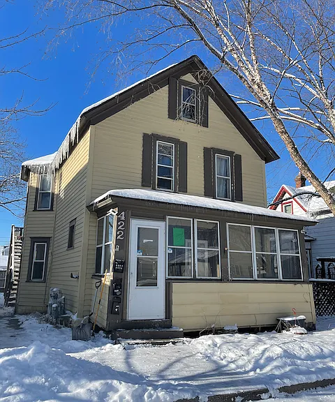422 4th Ave S duplex with entry porch, fenced yard, and off-street parking in the back.