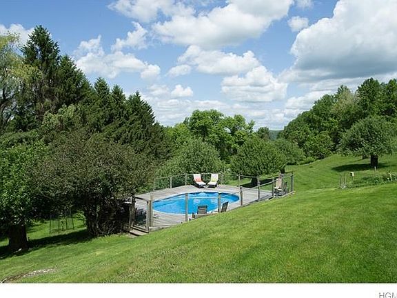 Pool is surrounded by apple orchard