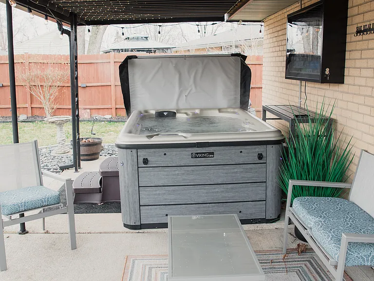 The ultimate relaxation spot! Soak your worries away in our private hot tub, nestled under a cozy covered patio with magical string lights.