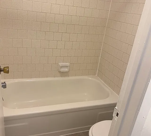 Light Grey Floor with white tile Restroom and toilet