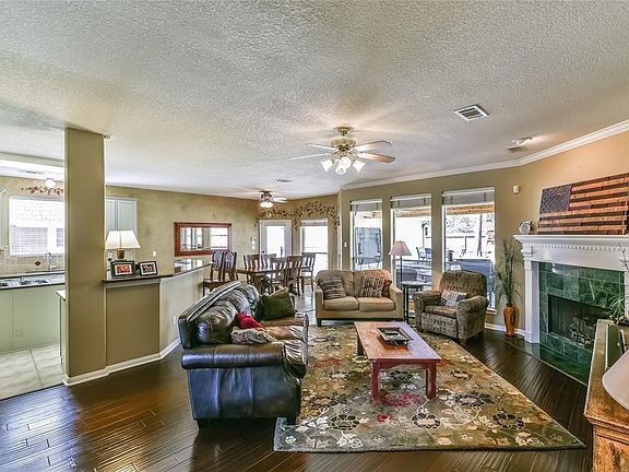 Family Room surrounds a fireplace and is open to the Island Kitchen and breakfast room.