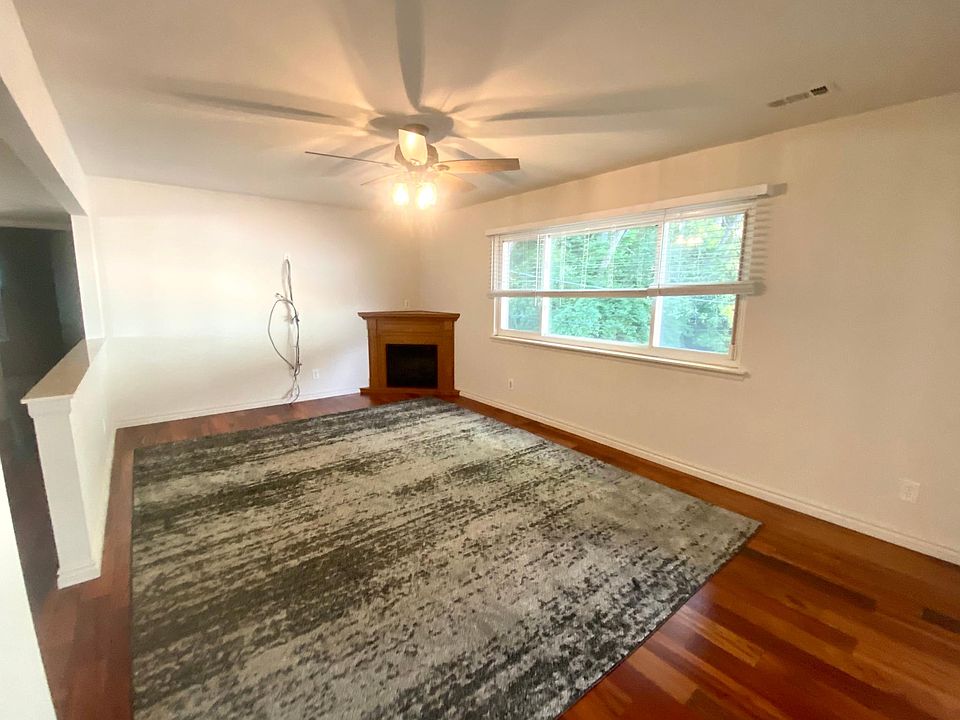 Spacious 2 Bedroom 1.5 Bath - Rochester, MI Living Room- Features: Cordless White Blinds, TV Wall Mount Wires + Electric Fireplace