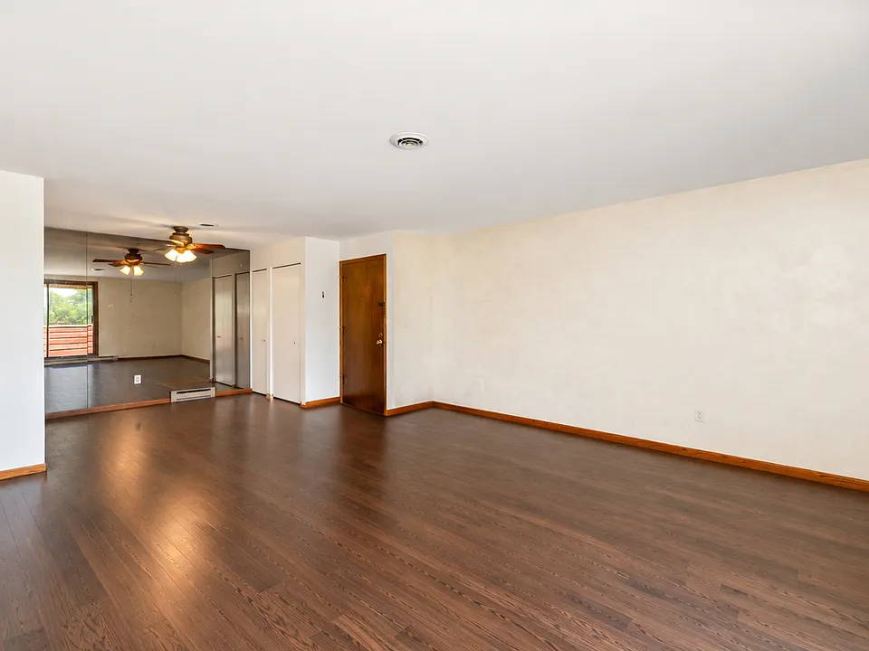 Generously Sized Living Room - Photo has been digitally altered to show new flooring being installed. Color is not exact.