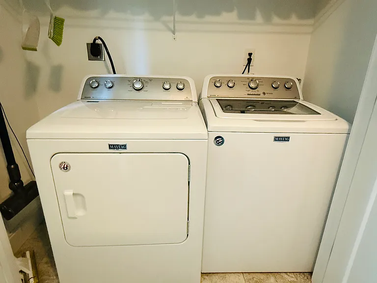 Closet with washer and dryer within the powder bathroom on the first floor.