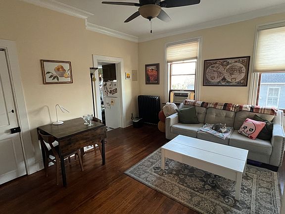 Dining living room, large Pella windows custom top down bottom up shades, original wood floors!