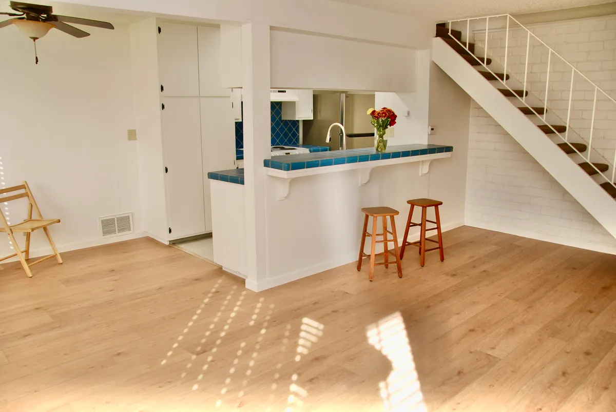 View towards kitchen, breakfast bar and stairs to upstairs with part of dining area on left - 2468 Plata Ct