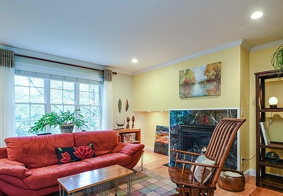 living room includes wooden blinds.