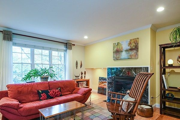 living room includes wooden blinds.