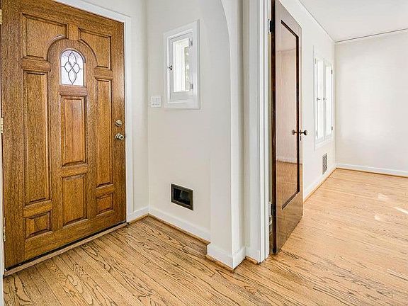 Front door & entryway looking into downstairs bedroom.