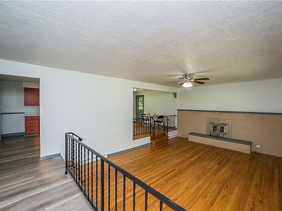 Large sunken living room w/ wood burning fireplace