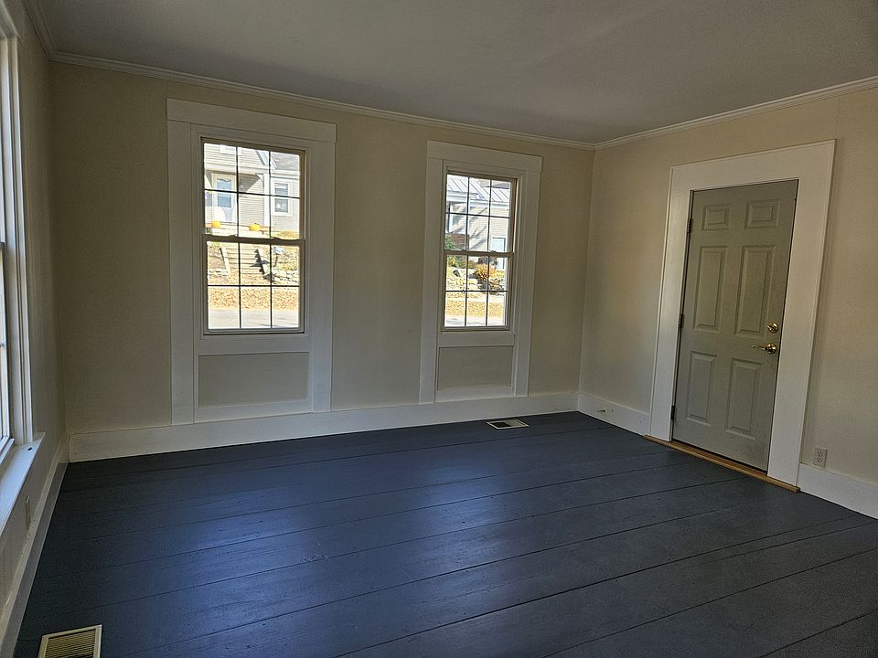 Well-proportioned living room with wide pine floor. Door to right leads to the entrance foyer