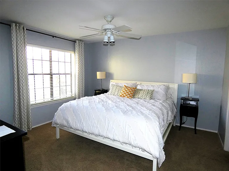 This bedroom includes a king size bed and bathroom.