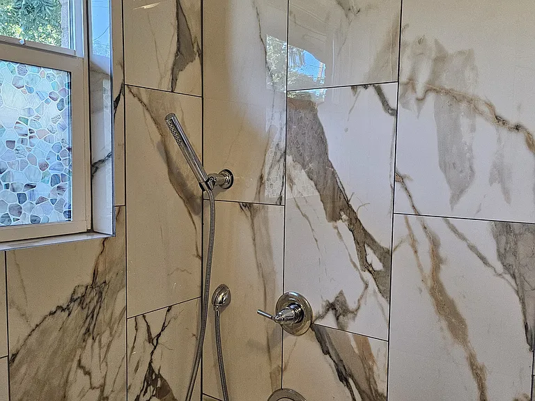 Notice the handheld wand and large shower head