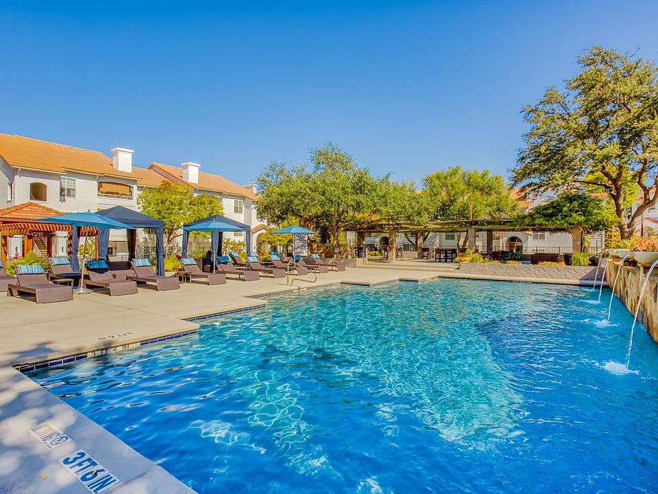 Glimmering pool area featuring soft-top cabanas
