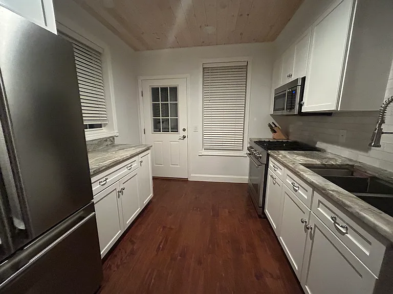kitchen has stainless steel appliances - gas range, deep double sink, microwave, granite countertops, large fridge and freezer, and ample storage