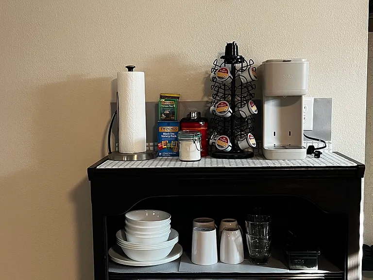 The kitchenette corner is stocked for light meals and easy mornings.