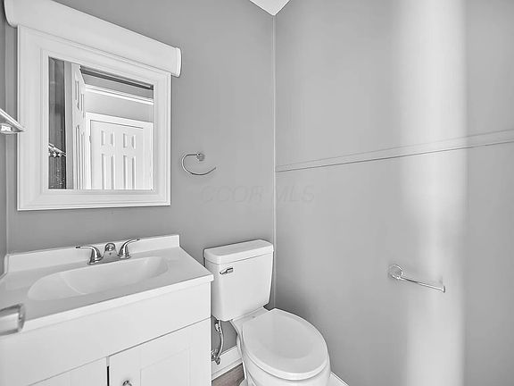 Half bathroom on the first floor, located in the hallway between the living room and bathroom.