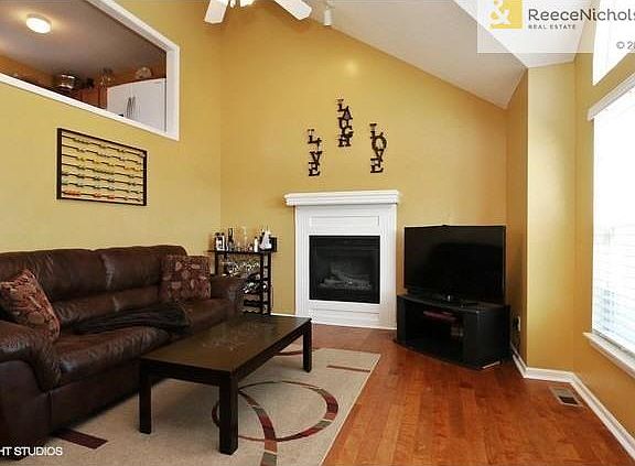 Family room with vaulted ceiling, hardwood floors, ceiling fan and fireplace.  It will accommodate large gatherings or for those intimate evenings.