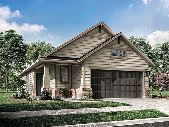 A two-story residential house with a garage, surrounded by lush greenery and a well-manicured lawn i