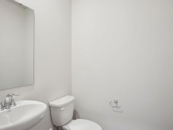 The half bathroom is conveniently located on the first floor for guests and visitors.