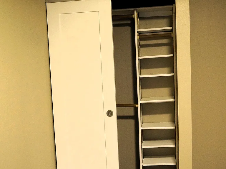 Secondary bedroom closet with removable storage shelves or hanging rod for longer clothing.