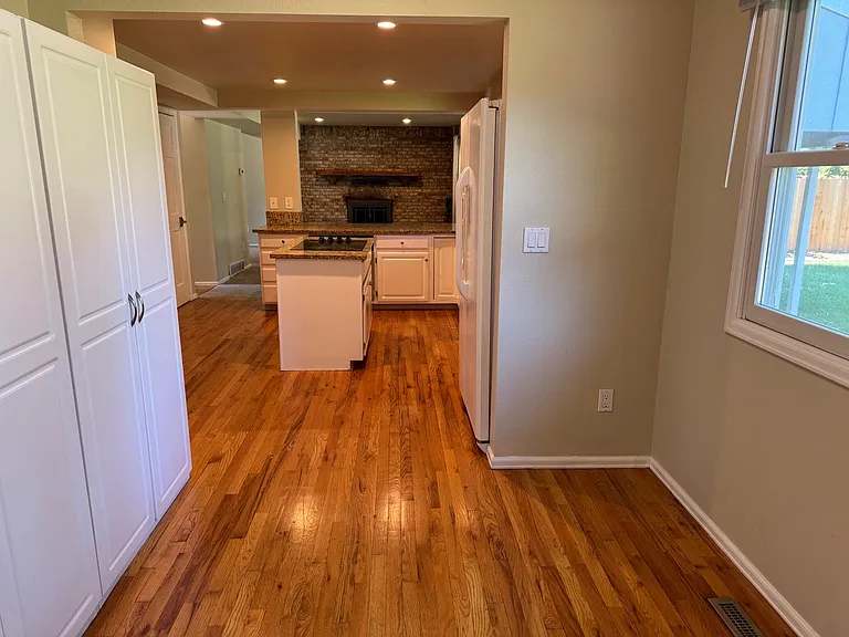 Pantry cabinets and room for a desk or table as you enter from the garage.
