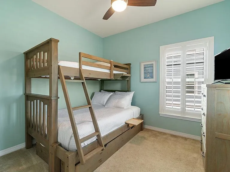 Bunk room with full bed on bottom, twin on top , and pull out twin trundle bed. This room is located on the same floor as kitchen and living room with a full bathroom right outside the room.
