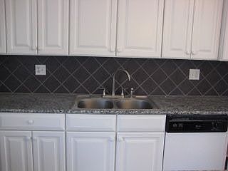 Tile back splash with dishwasher.
