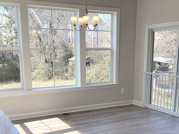 Morning room with large triple window and sliding glass door in a DRB Homes Colton II plan in the Ba