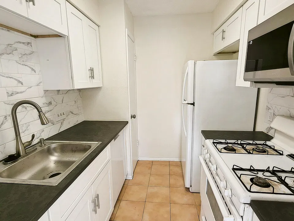 Updated kitchen with new cabinets, quartz countertop, backsplash, and more