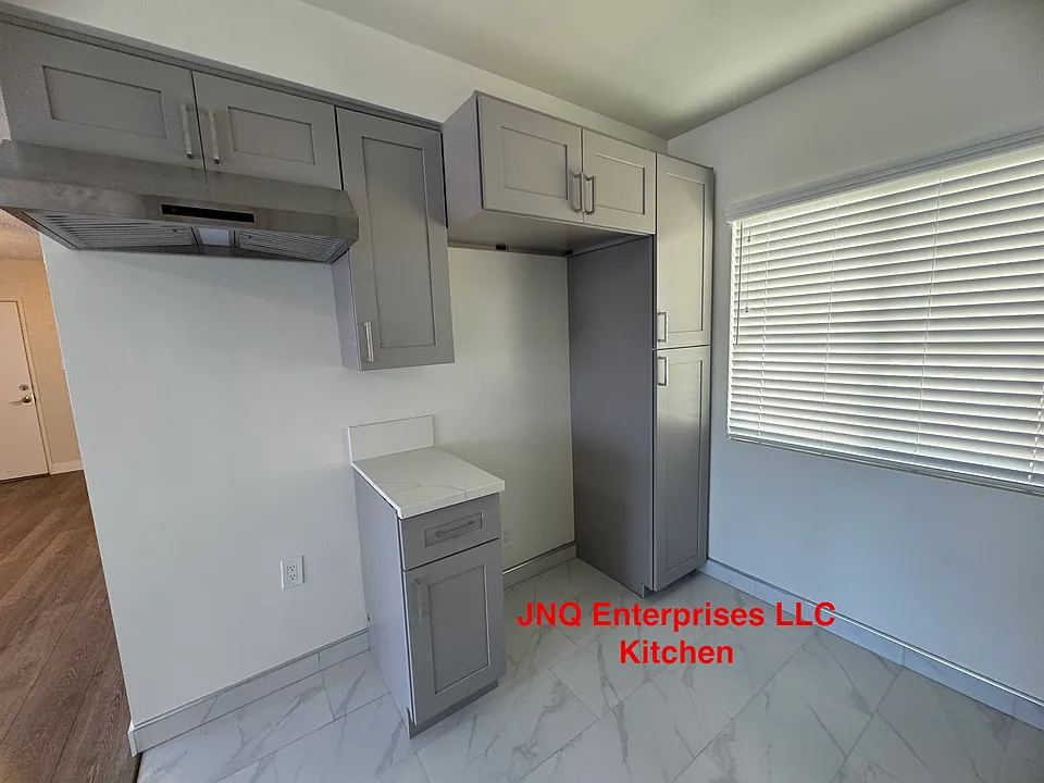 Remodeled kitchen has plenty of cabinet space on both sides. Kitchen window provides nice sunlight.