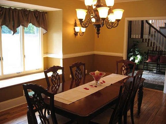 Dining room can seat 12  and has a built in window seat and heavy chandelier
